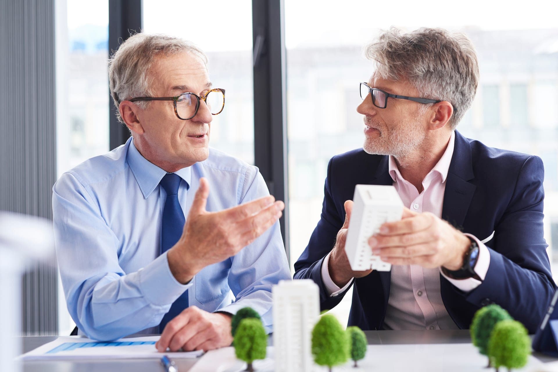 two-mature-architects-discussing-business